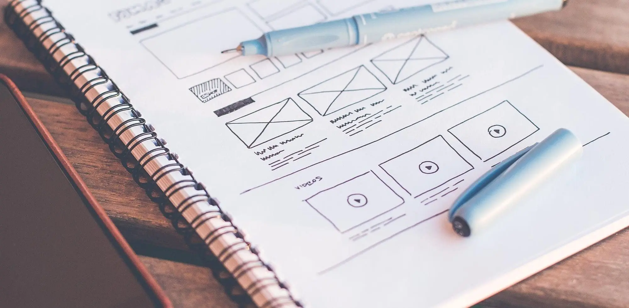 a notebook with wireframe drawings
