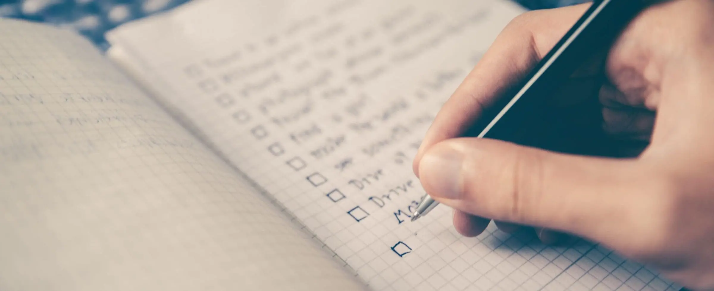 A person writing on a notebook