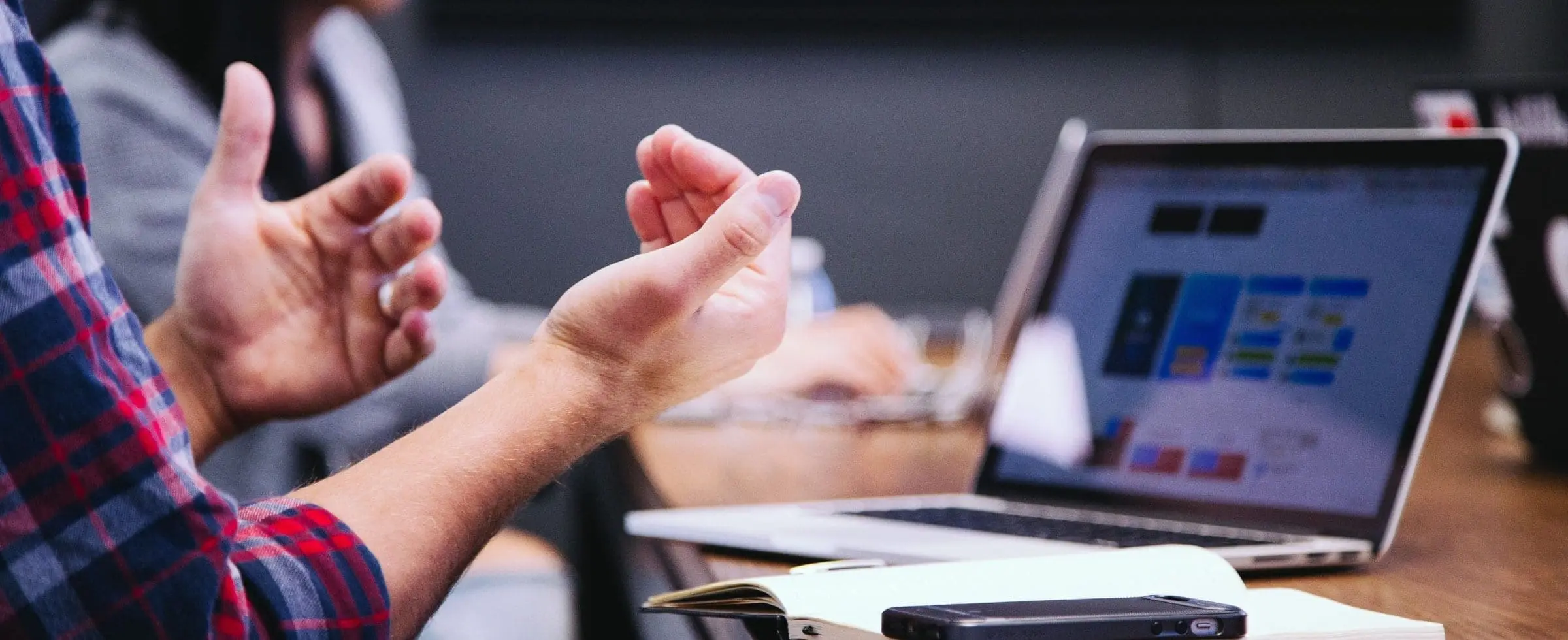 a person in a meeting doing hand gestures