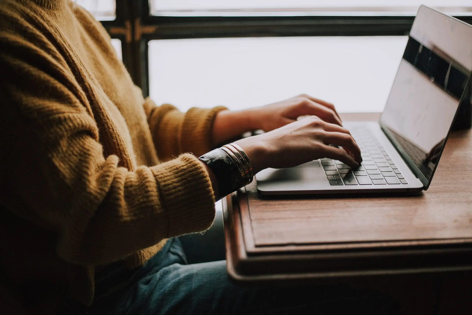 a person sitting in front of laptop