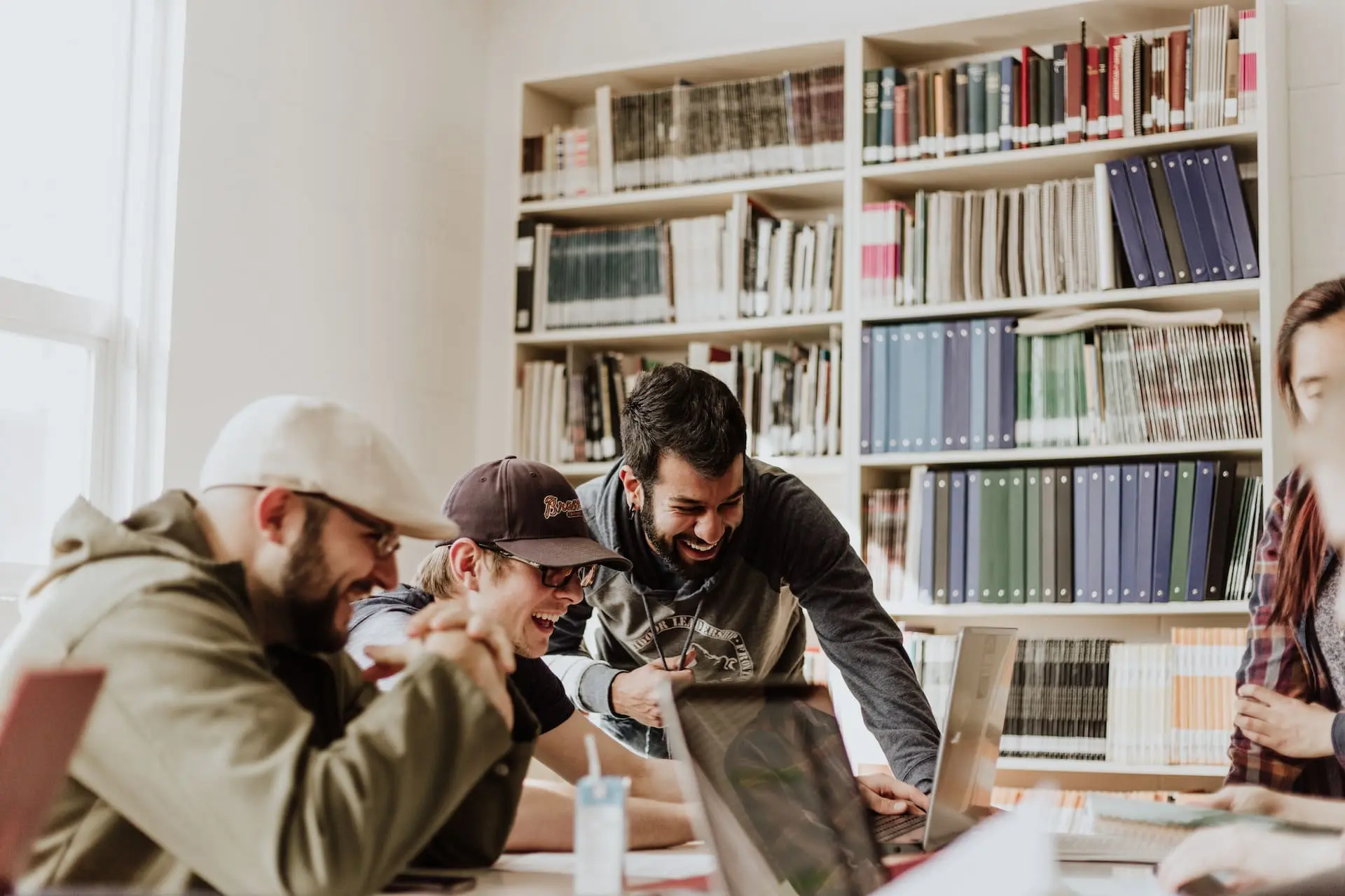 a group of people smiling at the computer