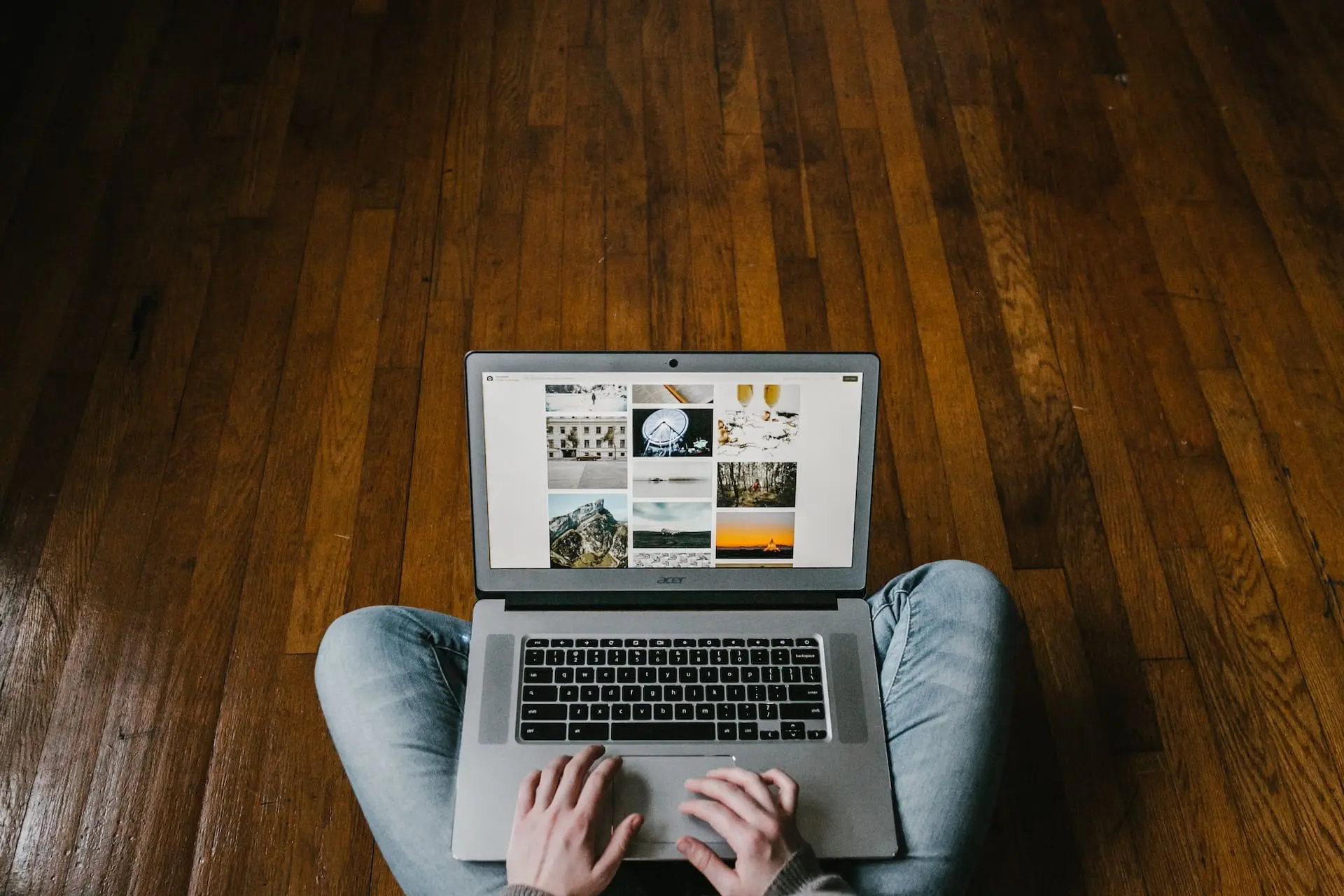 a person sitting on the floor using a laptop