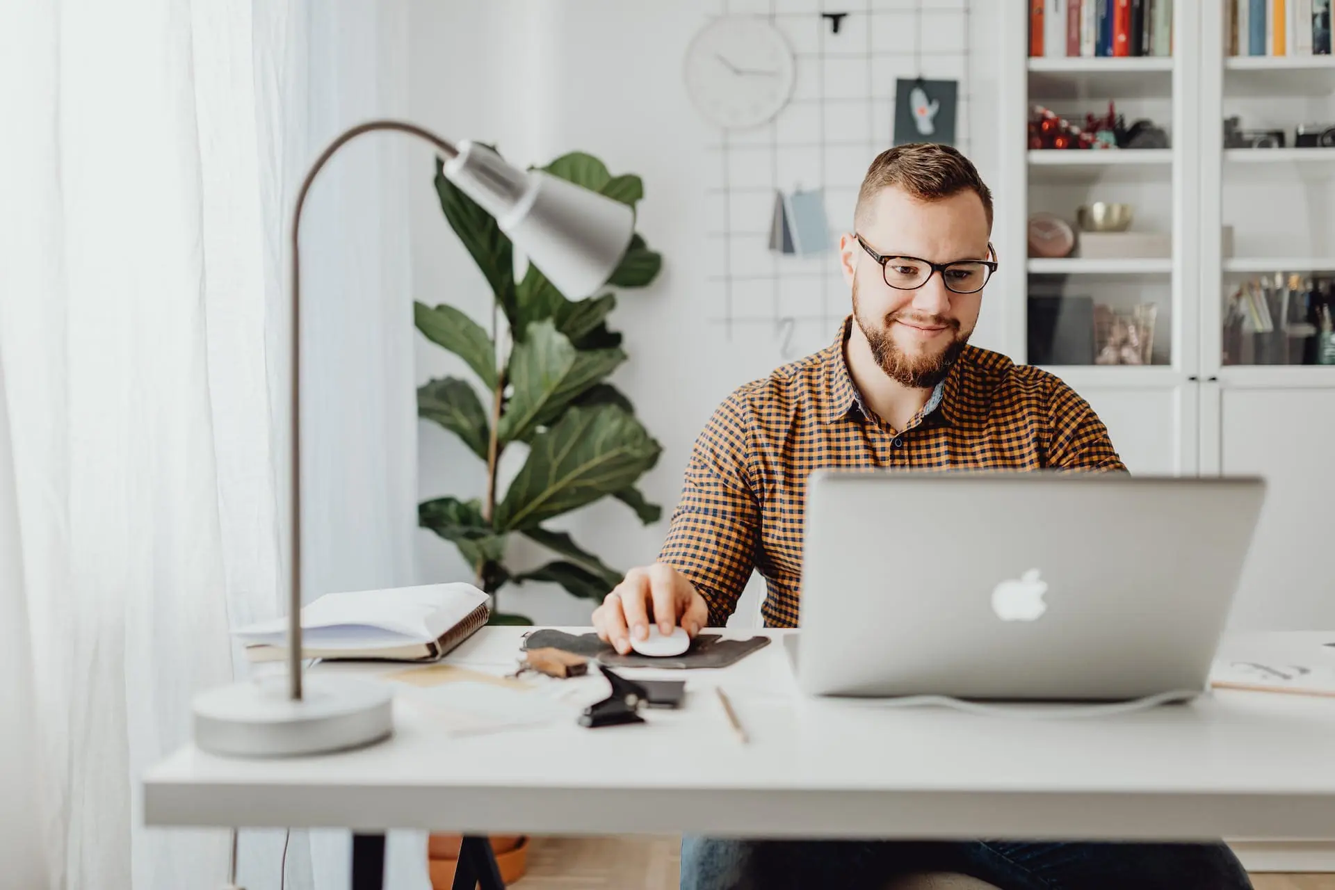 a man using a grey macbook
