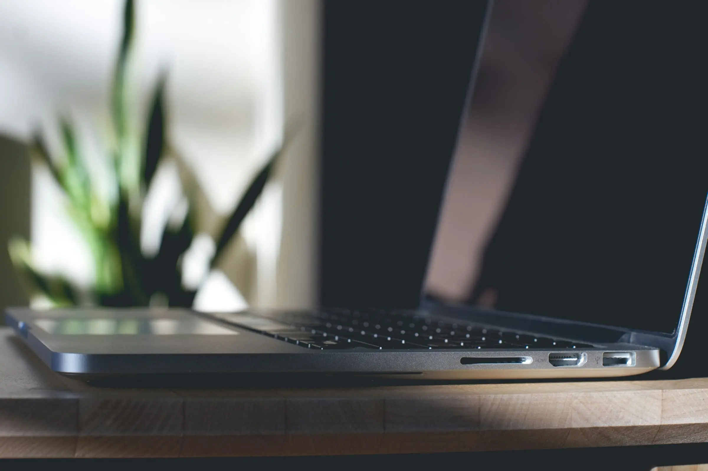 grey macbook on top of table