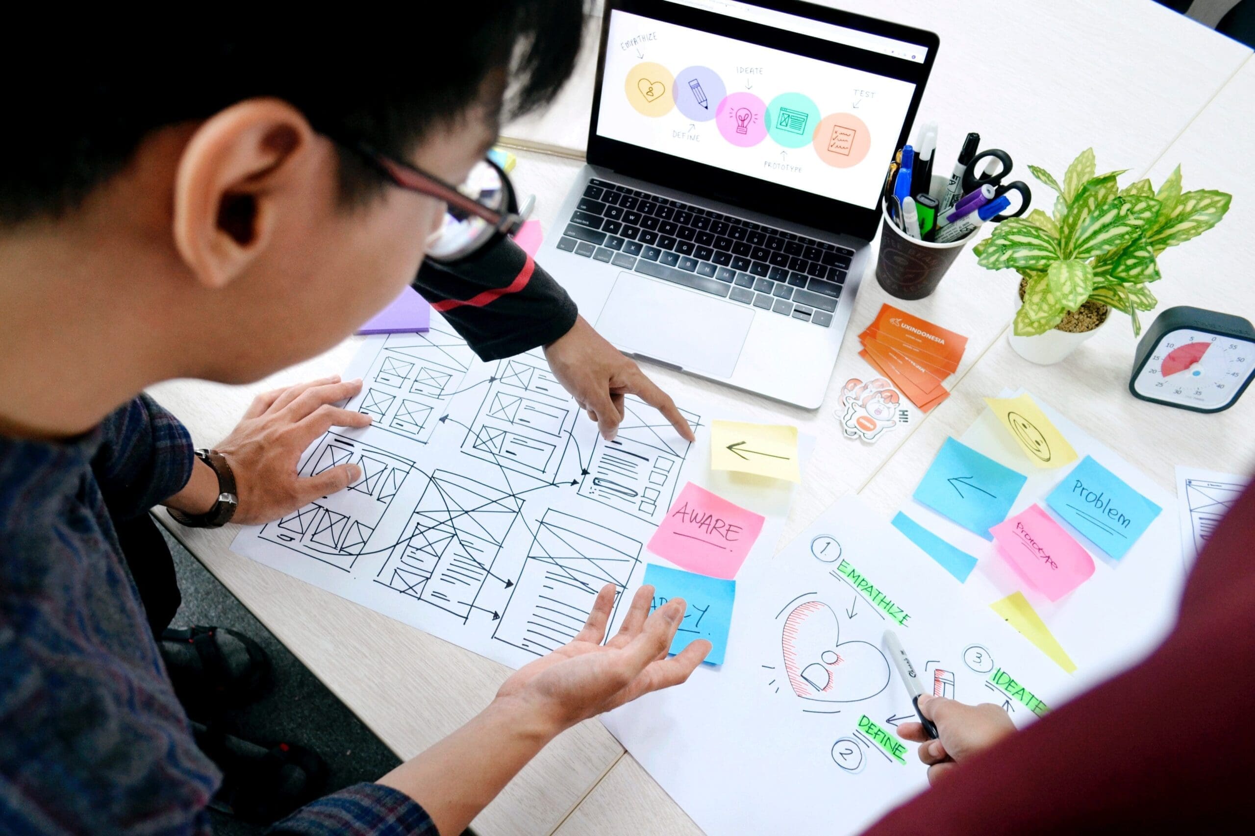 man drawing wireframes on paper
