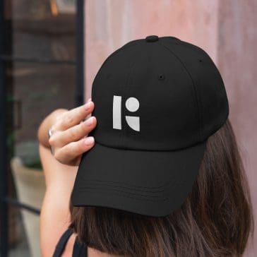 woman wearing hat with hey reliable "R" logo on front