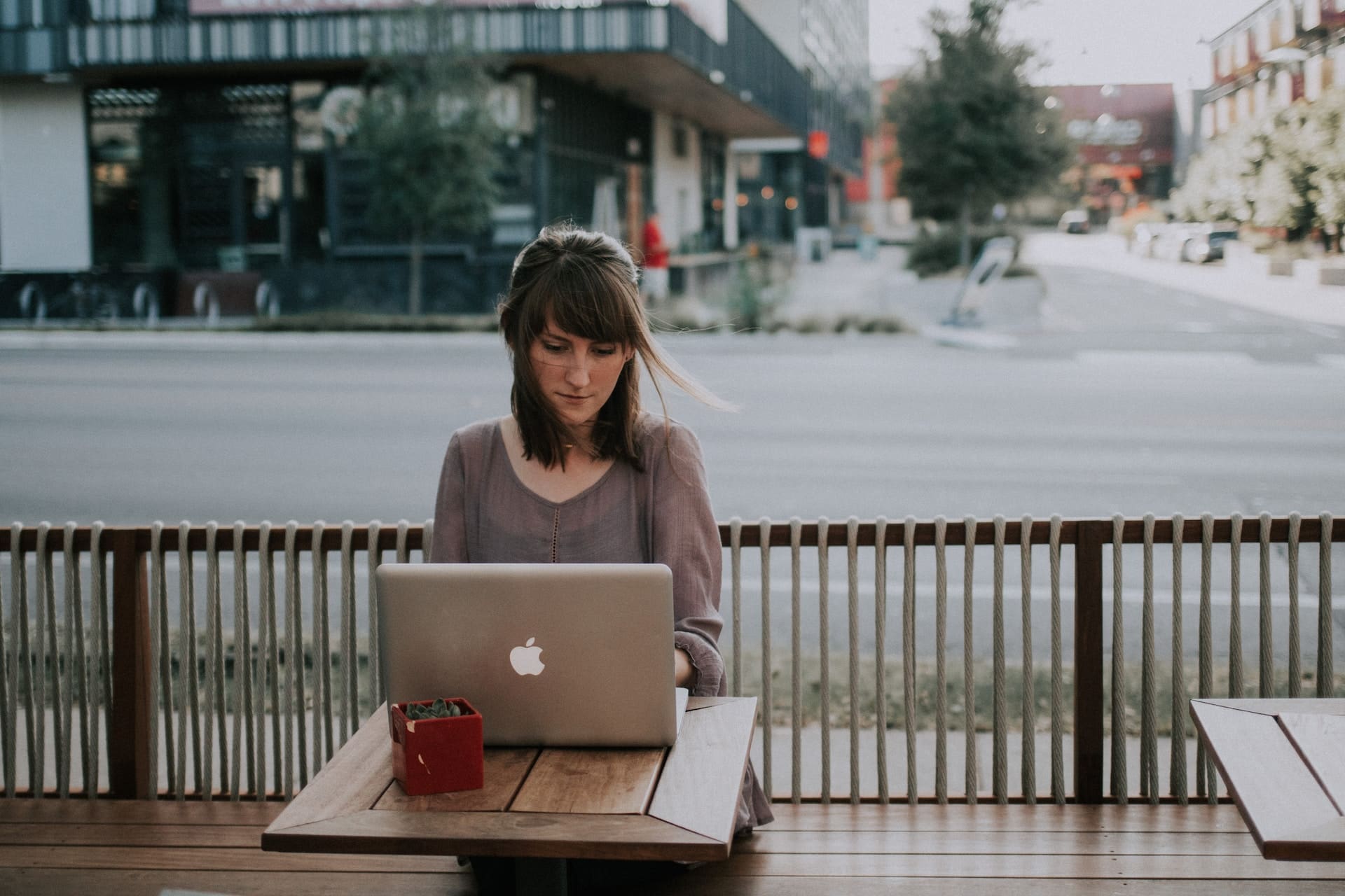 a woman using a laptop outdoors